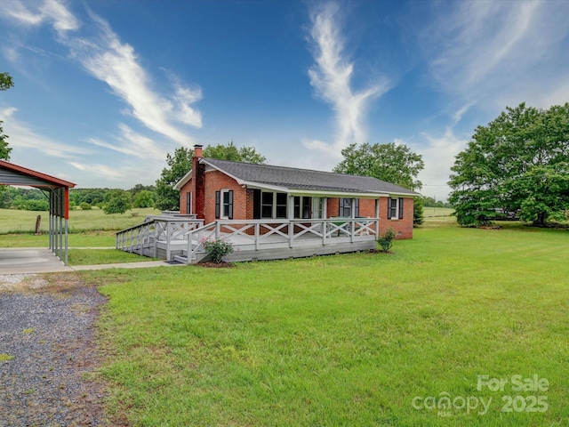 1155 Hasty Rd, Peachland, NC 28133 - back of property featuring brick siding, a deck, a yard, a chimney, and gravel driveway