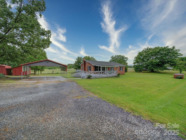 1155 Hasty Rd, Peachland, NC 28133 - single story home with gravel driveway, a front yard, a detached carport, and a wooden deck