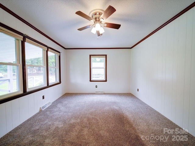 1155 Hasty Rd, Peachland, NC 28133 - carpeted empty room with ornamental molding, ceiling fan, a textured ceiling, and wooden walls