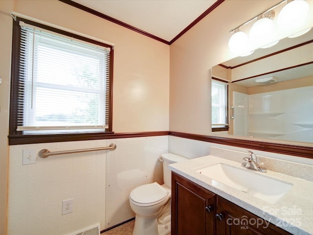 1155 Hasty Rd, Peachland, NC 28133 - bathroom featuring crown molding, tile walls, toilet, vanity, and wainscoting
