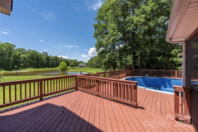 6504 Sybil Ct, Indian Trail, NC 28079 - wooden deck featuring a water view, a yard, view of wooded area, and an empty pool