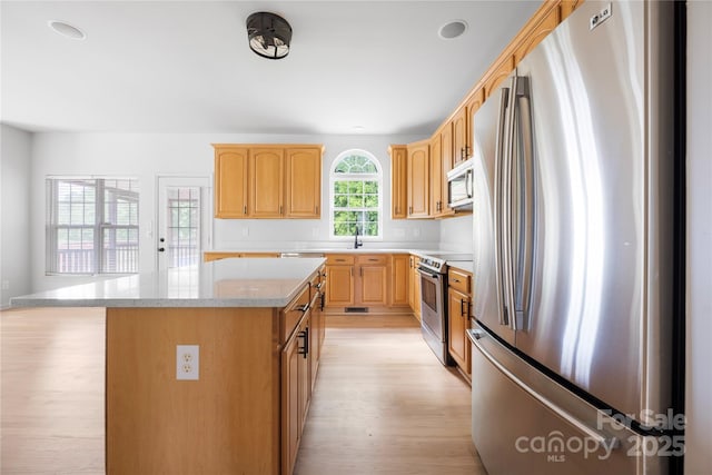 6504 Sybil Ct, Indian Trail, NC 28079 - kitchen featuring stainless steel appliances, light wood-style floors, a center island, light brown cabinets, and recessed lighting