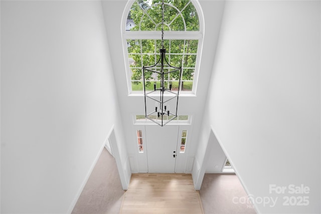 6504 Sybil Ct, Indian Trail, NC 28079 - foyer entrance featuring a chandelier, a towering ceiling, wood finished floors, and baseboards