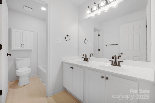 6504 Sybil Ct, Indian Trail, NC 28079 - full bath with double vanity, toilet, wood finished floors, and baseboards