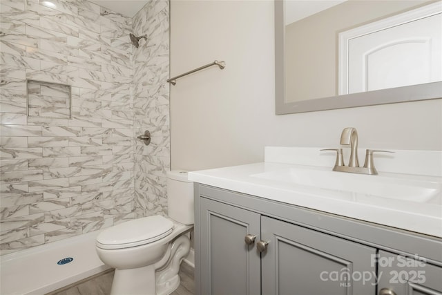 full bathroom with vanity, a stall shower, and toilet
