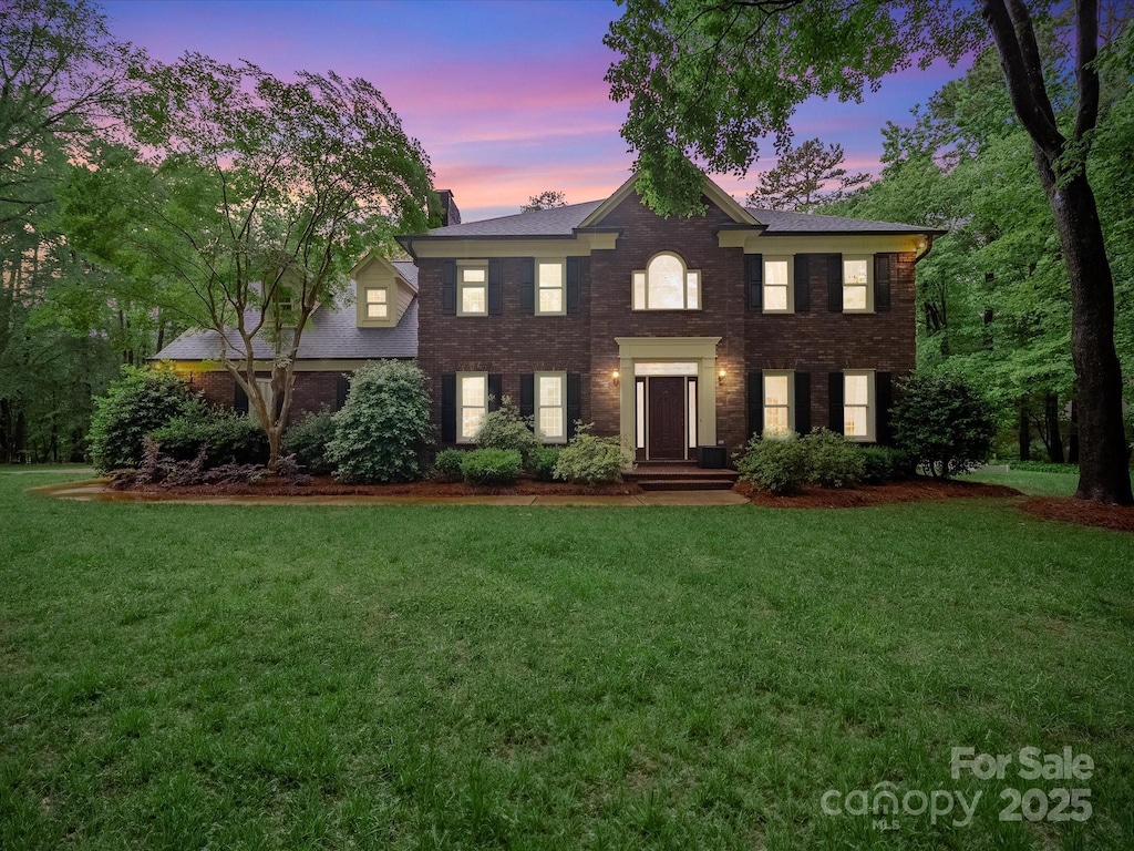 8527 Foxbridge Dr, Matthews, NC 28104 - georgian-style home featuring a lawn and brick siding