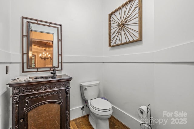 270 Sandhills Ct, Mooresville, NC 28115 - half bathroom featuring toilet, vanity, wood finished floors, and a chandelier