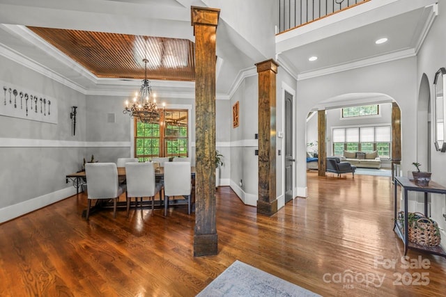 270 Sandhills Ct, Mooresville, NC 28115 - dining space featuring arched walkways, a chandelier, wood finished floors, crown molding, and baseboards