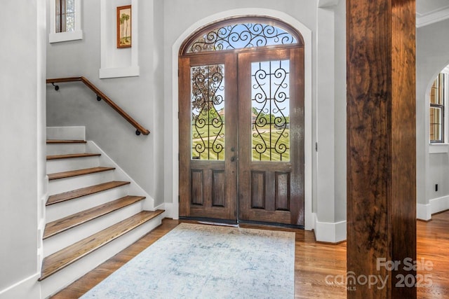 270 Sandhills Ct, Mooresville, NC 28115 - entryway featuring arched walkways, stairway, and wood finished floors