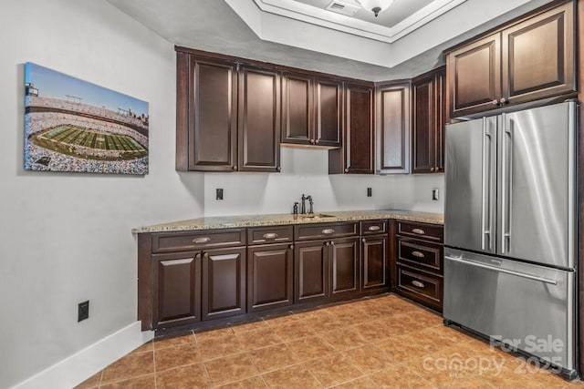 270 Sandhills Ct, Mooresville, NC 28115 - kitchen with high end refrigerator, dark brown cabinets, light stone counters, and a raised ceiling