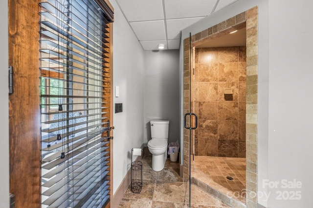 270 Sandhills Ct, Mooresville, NC 28115 - bathroom with toilet, stone tile flooring, a shower stall, baseboards, and a drop ceiling
