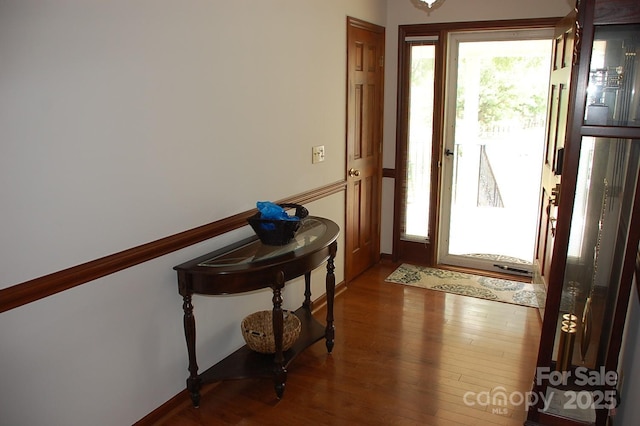 entrance foyer with wood finished floors and baseboards