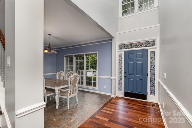 17318 Cambridge Grove Dr, Huntersville, NC 28078 - entrance foyer with a chandelier, crown molding, baseboards, a towering ceiling, and wood finished floors