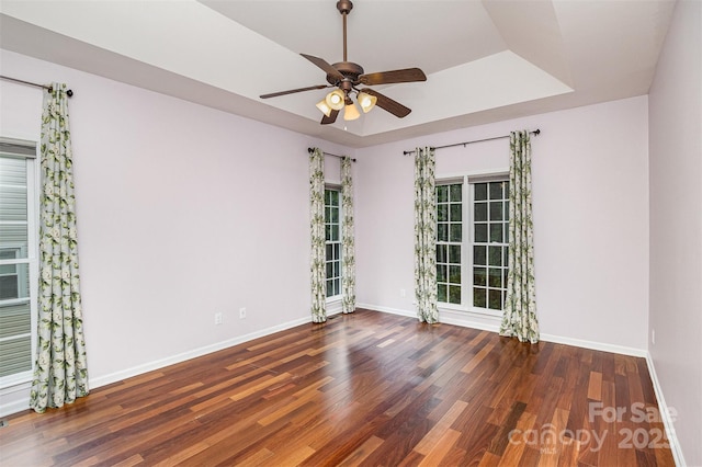 17318 Cambridge Grove Dr, Huntersville, NC 28078 - unfurnished room with baseboards, a ceiling fan, wood finished floors, and a tray ceiling