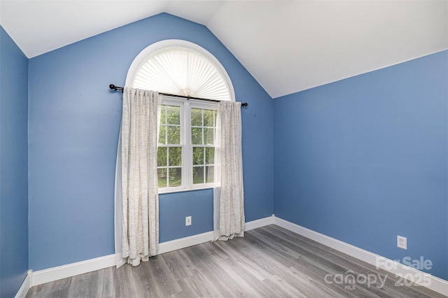 17318 Cambridge Grove Dr, Huntersville, NC 28078 - spare room featuring lofted ceiling, wood finished floors, and baseboards