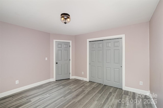 17318 Cambridge Grove Dr, Huntersville, NC 28078 - unfurnished bedroom with wood finished floors, baseboards, and a closet