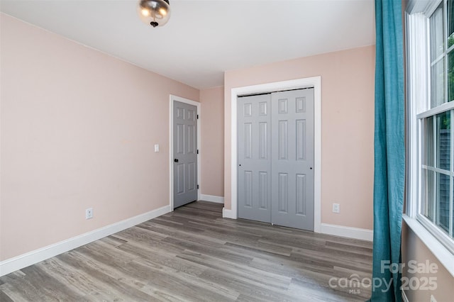 17318 Cambridge Grove Dr, Huntersville, NC 28078 - unfurnished bedroom featuring wood finished floors, baseboards, and a closet