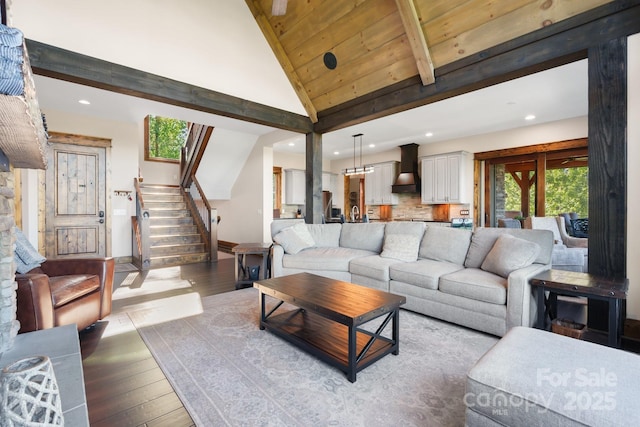 living area featuring recessed lighting, light wood finished floors, stairway, beam ceiling, and high vaulted ceiling
