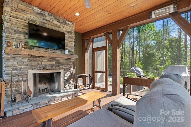 living room featuring wooden ceiling, wood finished floors, an outdoor stone fireplace, and recessed lighting
