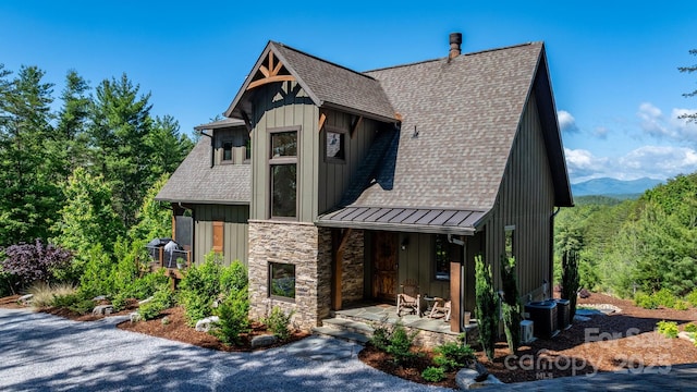 2775 Campbells Trce, Nebo, NC 28761 - view of front of home featuring a standing seam roof, covered porch, a shingled roof, stone siding, and board and batten siding