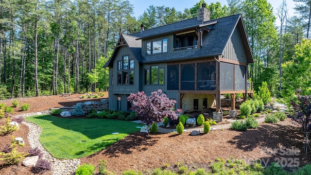 2775 Campbells Trce, Nebo, NC 28761 - rear view of house featuring a sunroom, a chimney, a shingled roof, and a yard