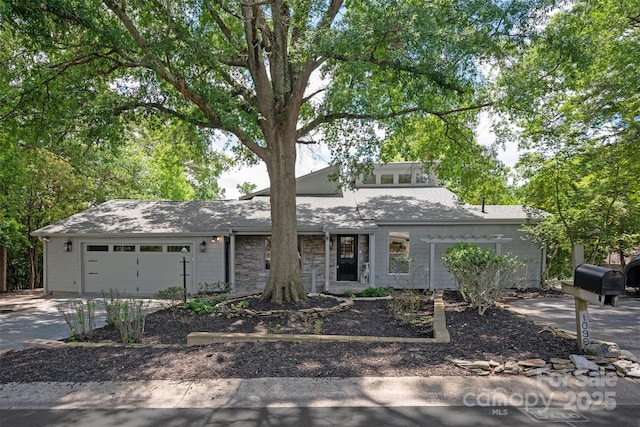 1096 Palmyra Dr, Tega Cay, SC 29708 - mid-century home featuring driveway, an attached garage, stone siding, and roof with shingles