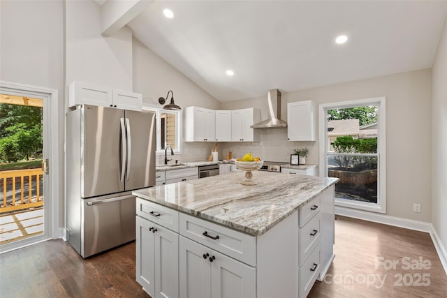 1096 Palmyra Dr, Tega Cay, SC 29708 - kitchen with appliances with stainless steel finishes, wall chimney range hood, a kitchen island, white cabinets, and dark wood-style flooring