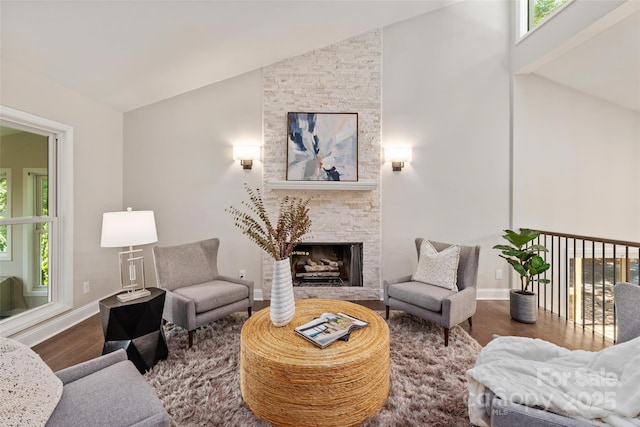 1096 Palmyra Dr, Tega Cay, SC 29708 - living room with wood finished floors, lofted ceiling, healthy amount of natural light, and a stone fireplace