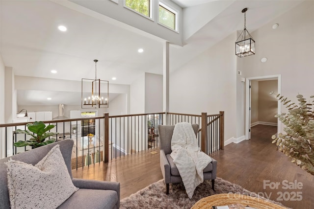 1096 Palmyra Dr, Tega Cay, SC 29708 - sitting room featuring a chandelier, wood finished floors, a high ceiling, recessed lighting, and an upstairs landing