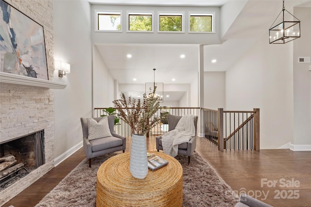 1096 Palmyra Dr, Tega Cay, SC 29708 - living area with a chandelier, an upstairs landing, a towering ceiling, wood finished floors, and recessed lighting