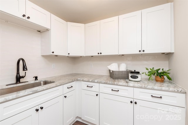 1096 Palmyra Dr, Tega Cay, SC 29708 - kitchen with white cabinetry, light stone countertops, and decorative backsplash