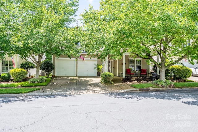 19539 Denae Lynn Dr, Cornelius, NC 28031 - view of property hidden behind natural elements with driveway, a porch, and an attached garage