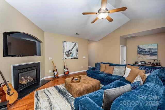 19539 Denae Lynn Dr, Cornelius, NC 28031 - living area featuring ceiling fan, wood finished floors, a glass covered fireplace, lofted ceiling, and baseboards