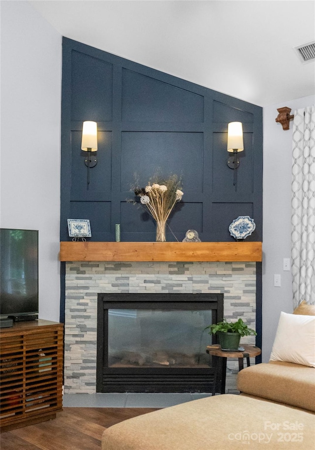 detailed view of a stone fireplace and wood finished floors
