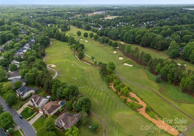 aerial view of property's location featuring a golf club