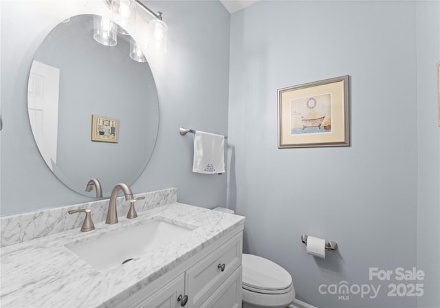 bathroom with toilet and vanity