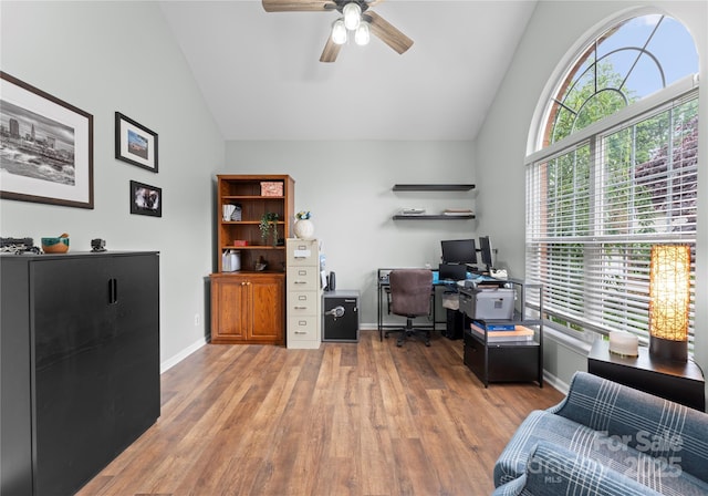 office area featuring ceiling fan, wood finished floors, baseboards, and high vaulted ceiling