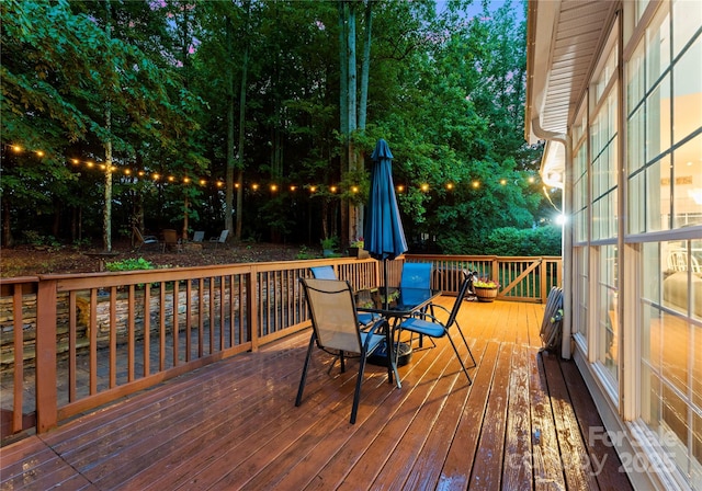 wooden terrace with outdoor dining area
