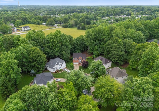aerial view of residential area featuring a heavily wooded area