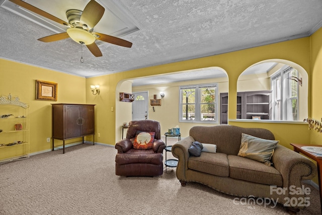 3905 NC Highway 213, Marshall, NC 28753 - carpeted living room featuring arched walkways, a textured ceiling, a ceiling fan, baseboards, and crown molding