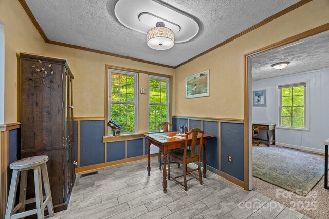 3905 NC Highway 213, Marshall, NC 28753 - dining area featuring a textured ceiling, crown molding, a wainscoted wall, and wood finished floors