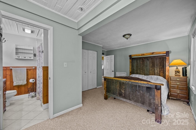 3905 NC Highway 213, Marshall, NC 28753 - carpeted bedroom featuring crown molding, a wainscoted wall, ensuite bath, baseboards, and a closet
