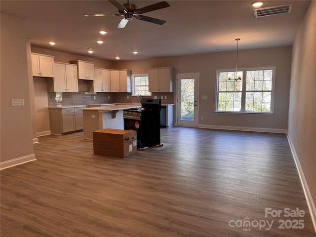 4041 Port Richmond Ave Unit 9, Gastonia, NC 28056 - kitchen with a center island, baseboards, dark wood-style floors, stove, and white cabinetry