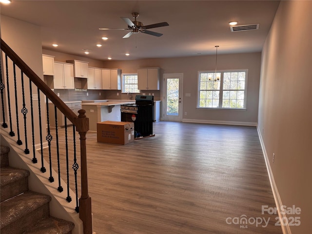 4041 Port Richmond Ave Unit 9, Gastonia, NC 28056 - kitchen with dark wood-type flooring, baseboards, white cabinetry, a center island, and recessed lighting