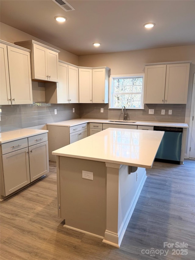 4041 Port Richmond Ave Unit 9, Gastonia, NC 28056 - kitchen featuring stainless steel dishwasher, a sink, a center island, tasteful backsplash, and light wood-style flooring
