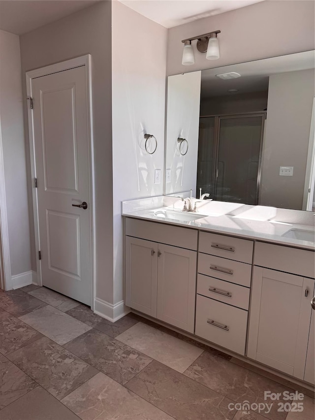 4041 Port Richmond Ave Unit 9, Gastonia, NC 28056 - bathroom with baseboards, double vanity, a stall shower, and stone finish flooring