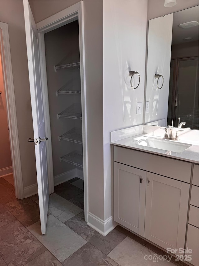 4041 Port Richmond Ave Unit 9, Gastonia, NC 28056 - bathroom featuring marble look tiles, baseboards, and vanity