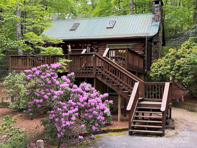 615 Sweetwater Rdg, Burnsville, NC 28714 - back of house with stairs, log siding, a wooden deck, a chimney, and metal roof