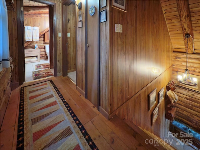 615 Sweetwater Rdg, Burnsville, NC 28714 - corridor featuring log walls, wood-type flooring, wood walls, and wooden ceiling