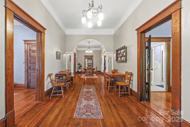 4569 Edgeland Rd, Edgemoor, SC 29712 - entryway with arched walkways, a chandelier, dark wood-style flooring, and ornamental molding